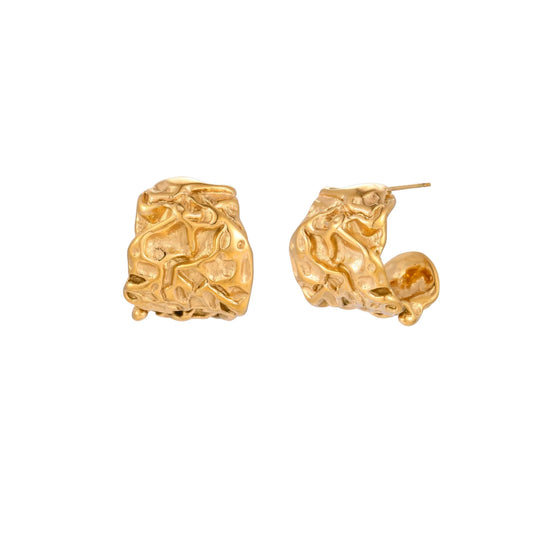Sculptural gold-plated hoops with organic crushed texture on cream background