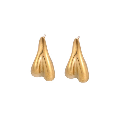 Pair of sculptural gold stud earrings with twisted organic forms on cream background
