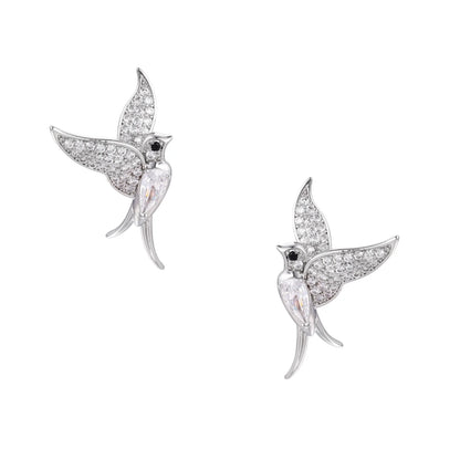 Pair of white gold-plated hummingbird stud earrings with pavé zirconia stones and teardrop crystal bodies on cream background