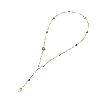 Y-shaped gold-plated necklace with white and gray freshwater pearls on cream background, showing adjustable drop design.