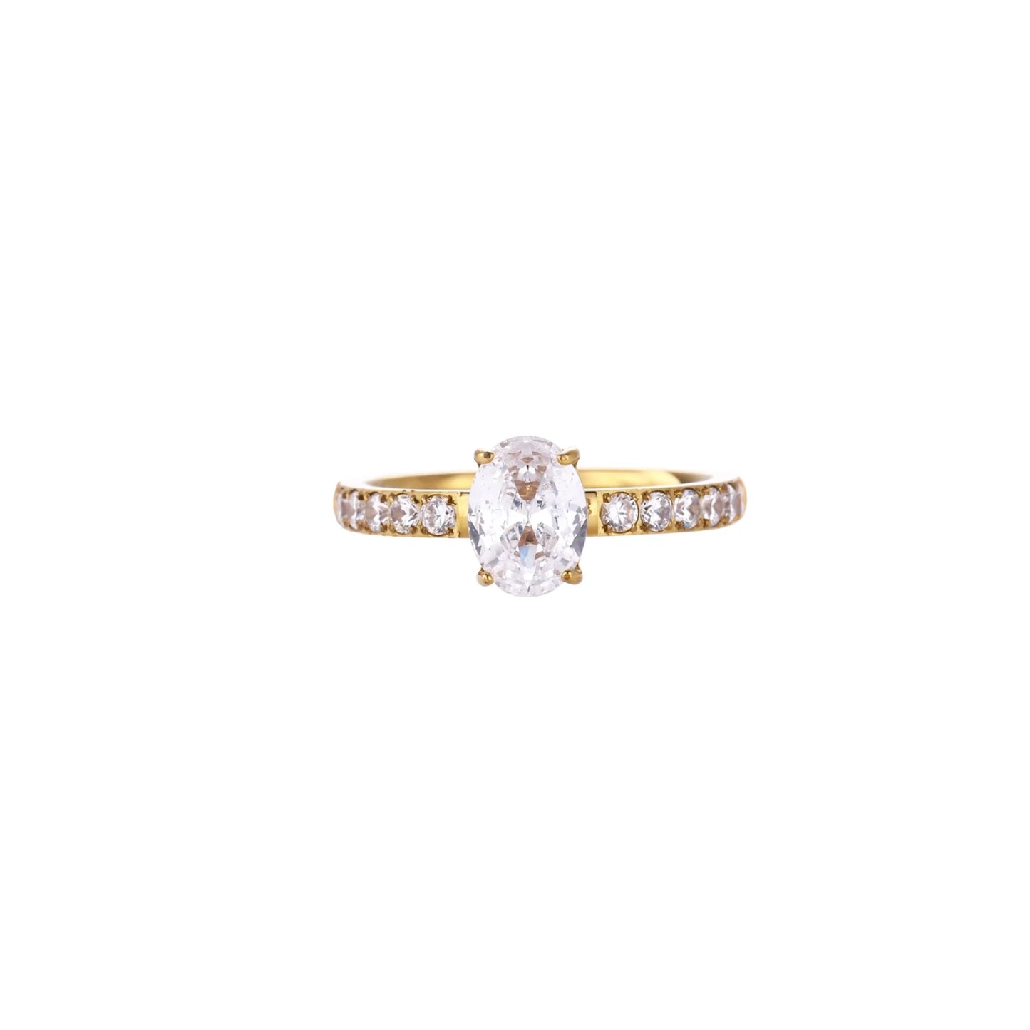 Gold-plated solitaire ring with oval zirconia center stone and pavé band on cream background