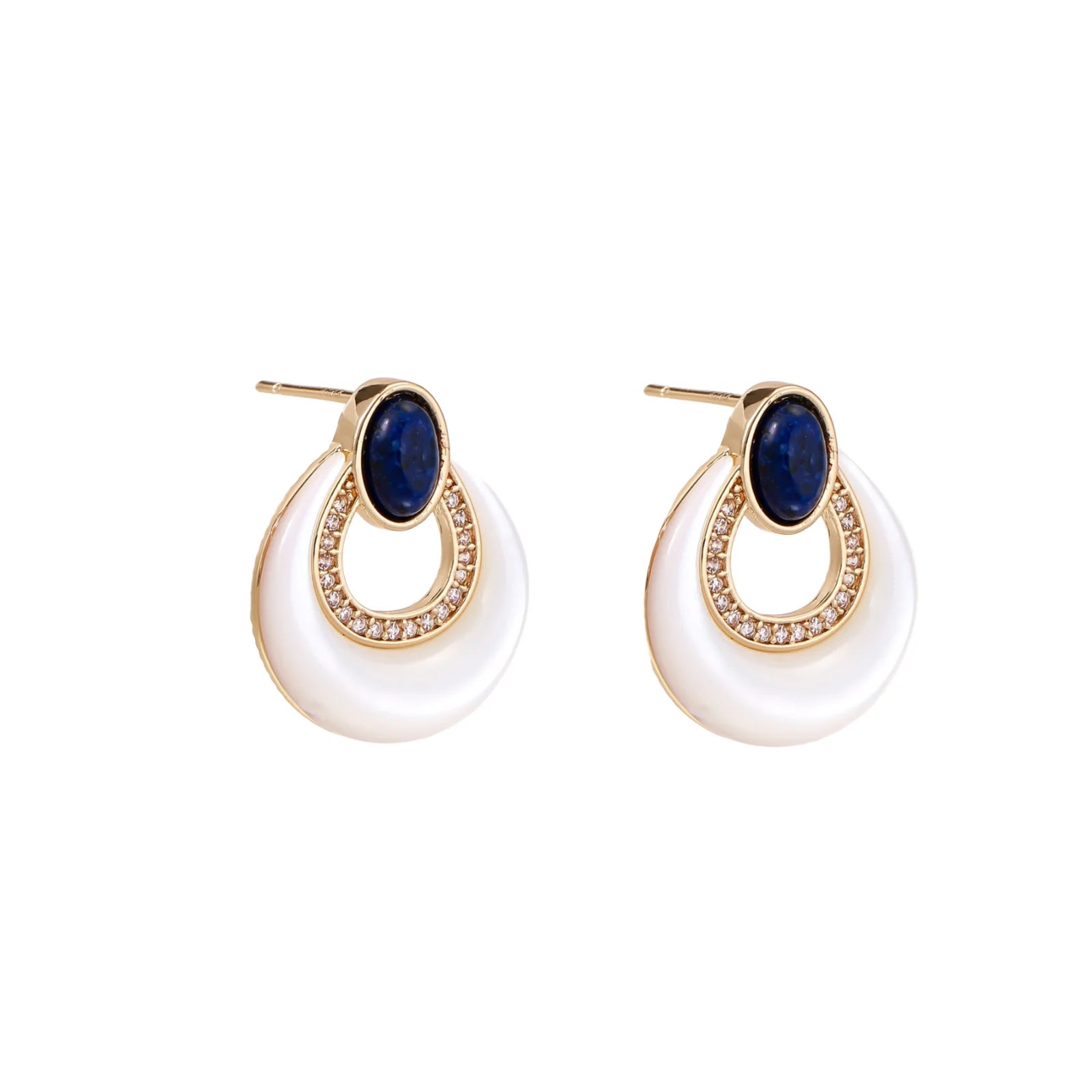 Gold drop earrings with oval lapis lazuli, crystal-paved frame, and iridescent mother-of-pearl teardrop on cream background