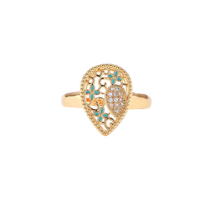 Teardrop-shaped gold-plated ring with turquoise enamel flowers and crystal pavé detail on cream background