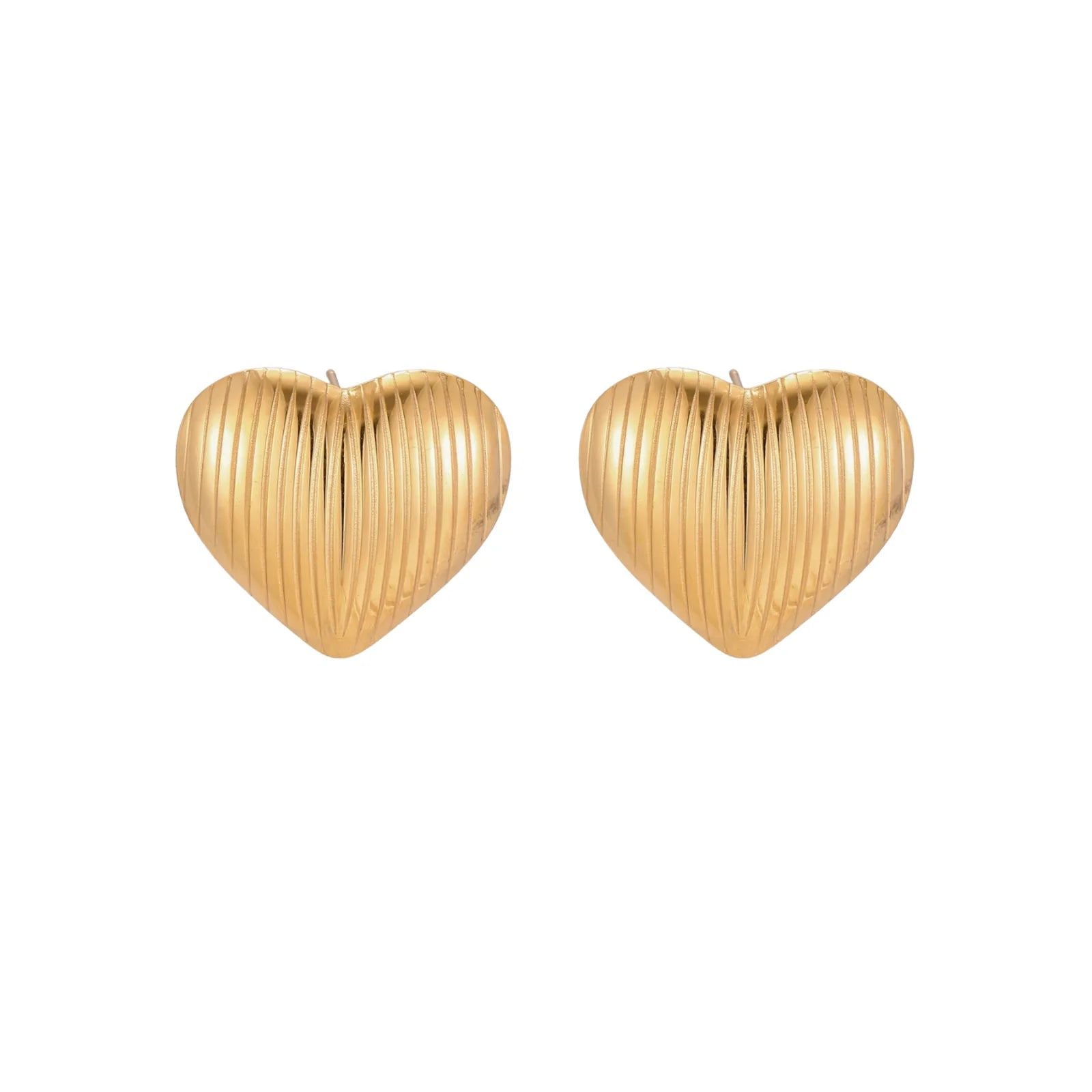 Gold heart-shaped stud earrings with parallel ridged texture on cream background