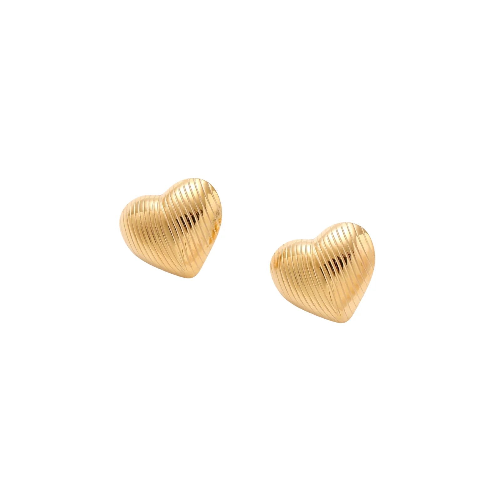 Gold heart-shaped stud earrings with parallel ridged texture on cream background