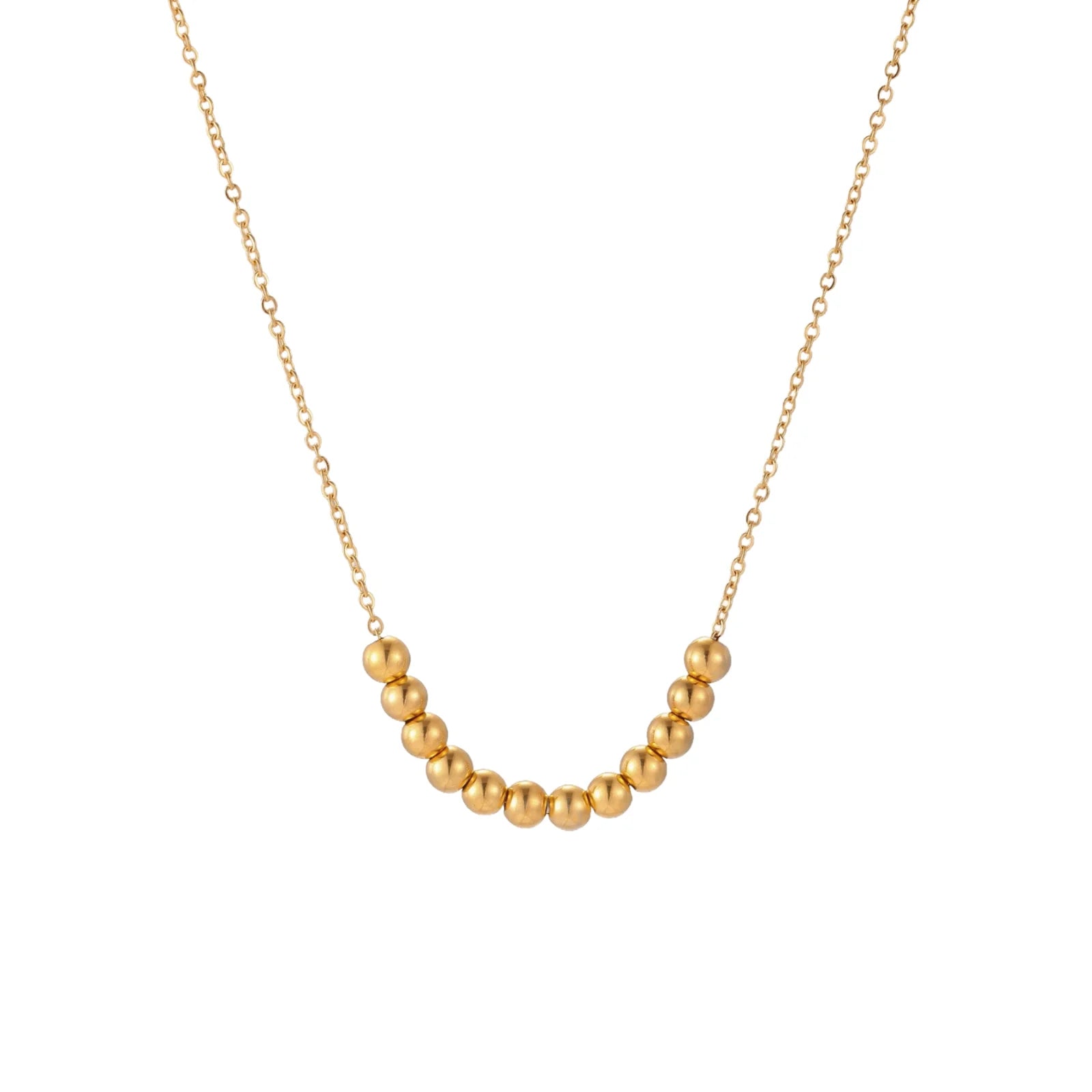 Delicate gold-plated necklace with graduated spherical beads forming gentle smile curve on beige background