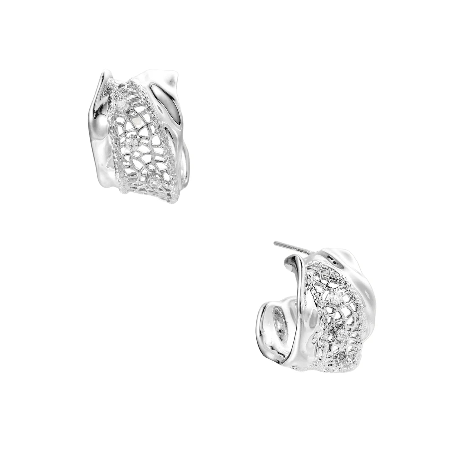 Close-up of sculptural hoop earrings with lattice center band and smooth twisted edges in white gold-plated brass with zirconia