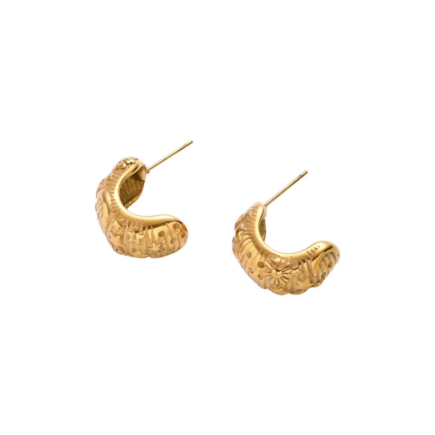 Gold-plated chunky hoop earrings with sun and star engravings on white background, showing detailed celestial pattern work.