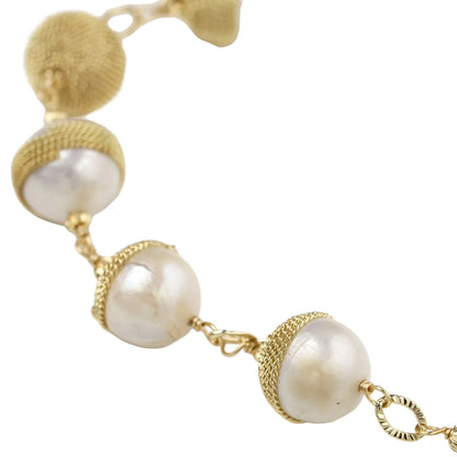 Adjustable bracelet with baroque pearls wrapped in delicate gold mesh netting connected by textured chain links
