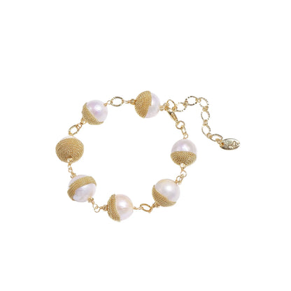 Adjustable bracelet with baroque pearls wrapped in delicate gold mesh netting connected by textured chain links