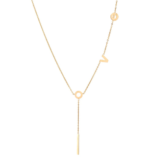 Gold Y-shaped necklace with L-O-V-E letter charms and vertical bar pendant on delicate chain against cream background