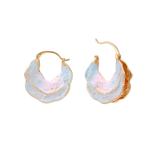 Shell-shaped hoop earrings with iridescent blue-pink enamel and gold trim on cream background