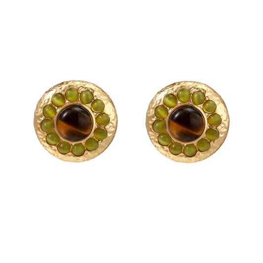 Round hammered gold studs with brown tiger's eye center surrounded by olive green liuli stones on white background.