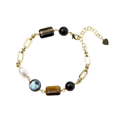 Gold chain bracelet with tiger's eye, obsidian, pearl, and iridescent abalone stones on cream background.