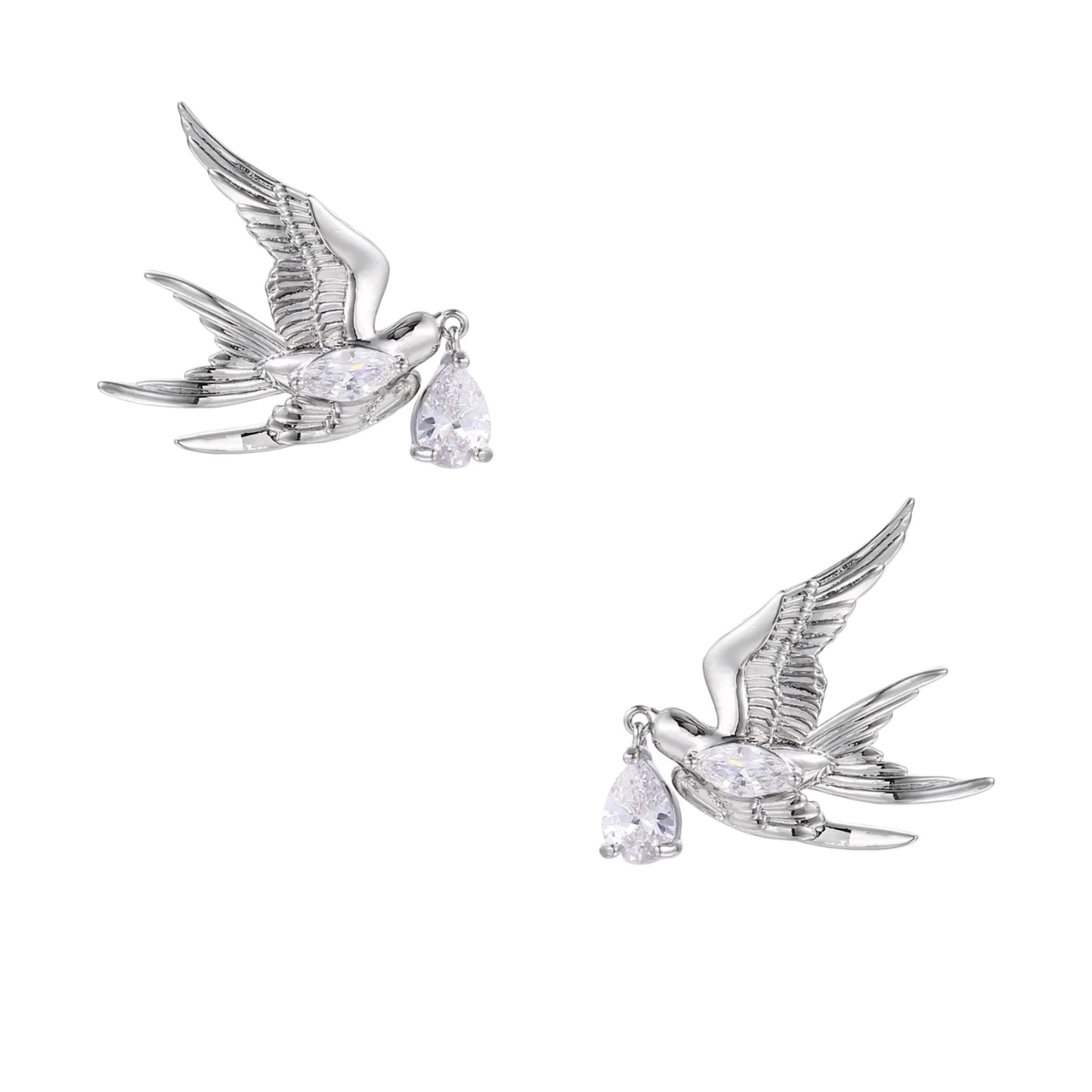 Silver-toned swallow stud earrings with detailed wings carrying teardrop zirconia crystals on white background
