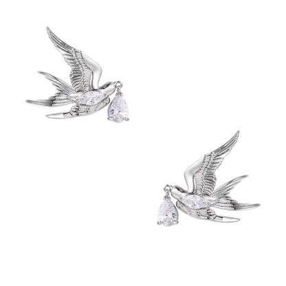 Silver-toned swallow stud earrings with detailed wings carrying teardrop zirconia crystals on white background