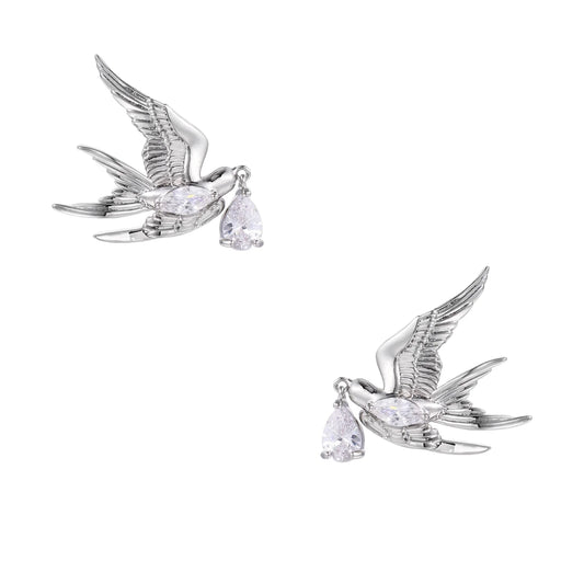 Silver-toned swallow stud earrings with detailed wings carrying teardrop zirconia crystals on white background