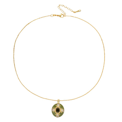 Gold-plated pendant necklace with green enamel background and oval olive cubic zirconia center stone with crystal accents.