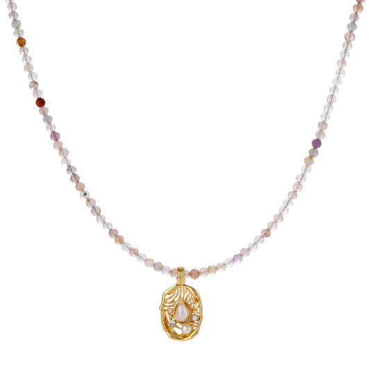Delicate gold-plated necklace with mixed gemstone beads and ornate oval pendant on white background