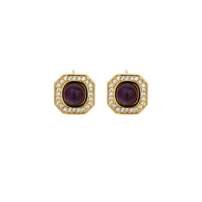 Gold-plated octagonal stud earrings with burgundy liuli centers and cubic zirconia halos on white background