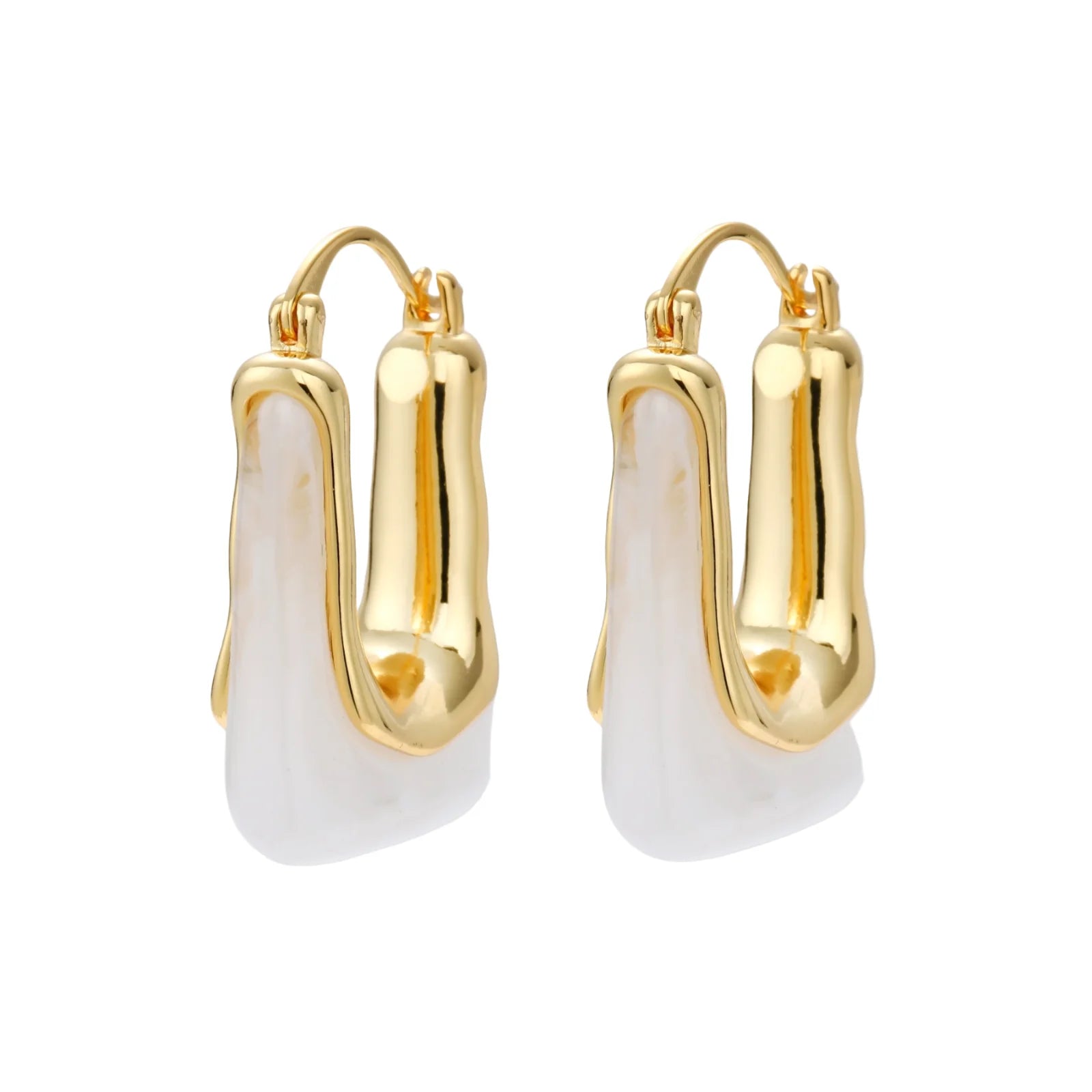 Sculptural gold-plated hoop earrings with flowing curved design and lever-back closure on cream background.